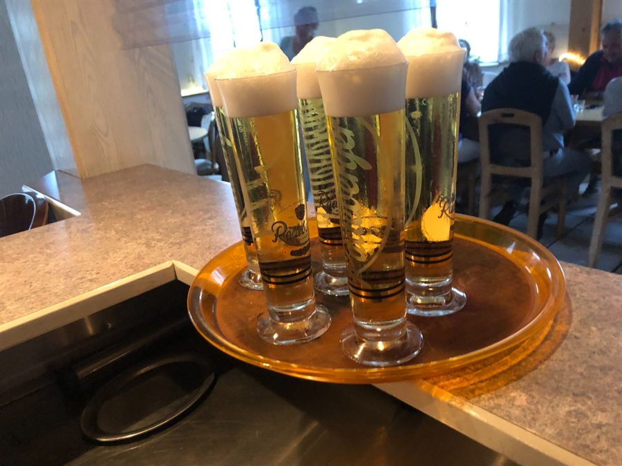 Vier frisch gezapfte Pils mit Schaumkrone am Tresen